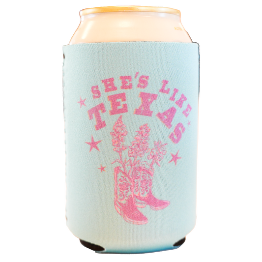 Light blue can cooler with pink ’She’s Wild Texas’ text and cowboy boot design.